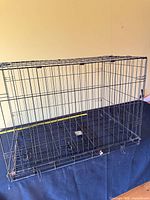 Dog crate set up showing wire construction and removable tray