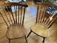 Both Windsor chairs front view on hardwood floor