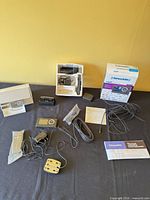 Full view of all components laid out: receiver, dock, power adapter, antenna, remote, cables, manuals, box