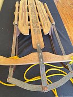 Angled top view showing deck graphics, steering bar, rope, and metal frame