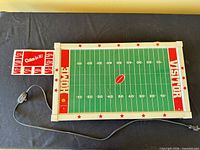 full view of game board, controller cord, and decal sheet on table