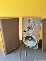 Pair of Technics SB-LX7 speakers, one with grille removed showing drivers