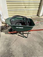 Full view of wheelbarrow with hose inside