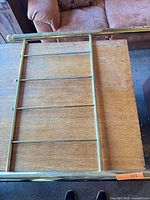 Full view of one brass twin headboard on table