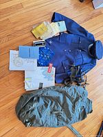 overview of all items including jacket, cap, duffel, oxygen mask, manuals, maps
