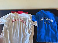 Rear view of both shirts showing FIRE-BALL and ASHLAND OIL embroidery