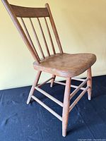 Full view of one spindle back chair showing overall design and structure