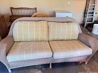 Front view of wicker loveseat showing cushions