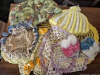 Group shot of doilies, placemats, tea cozies, baby booties