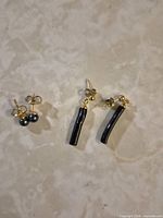 Both pairs of earrings on marble background