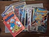Group shot showing seven comic books, several in plastic sleeves