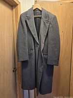 Front view of gray Crombie overcoat on hanger