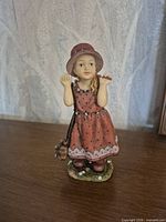 Front view of resin girl figurine with dog