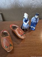 Front view of ceramic Dutch boy & girl shakers and wooden clogs