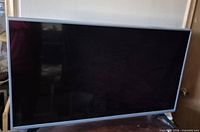 Front view of LG 43" TV, screen off, bezel visible