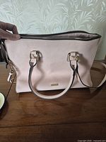 Front view of light pink ALDO tote showing handles, strap and zipper