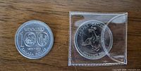 Obverse sides of both coins: Winnipeg Centennial coin loose, Grizzly coin in sleeve