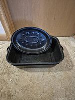 Large rectangular roaster showing interior and lid placed on edge