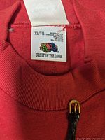 Fruit of the Loom size XL tag inside red sweatshirt