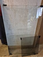 All three glass panels standing, showing relative sizes, tint difference and mounting clips