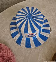 Blue and white striped plastic Dubble Bubble hat top view