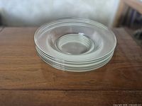 Stack of clear glass bowls showing matching size and style