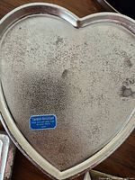 Heart-shaped silver-plated box interior with tarnish-resistant sticker