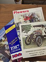 Stacked view showing Golden Age of Television 1987 calendar, Flowers calendar, Guaranteed Auto & Plate Glass Ltd calendar
