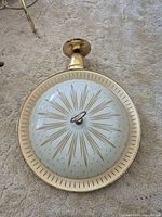 Top view of ceiling light showing starburst glass shade and brass rim