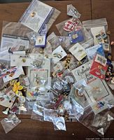 Overview of assorted lapel pins, packaged and loose