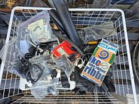 Basket containing assorted bicycle parts, boxed and bagged items visible
