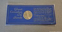 Obverse of gold-tone medallion in blue presentation card