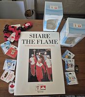 Group shot showing book, boxed glasses, pins, mitten keychains
