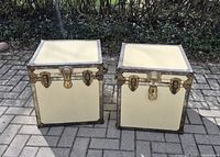 Front view of both cream square trunks showing hardware
