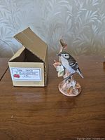 Porcelain mockingbird figurine front with box