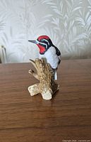 Front view of porcelain woodpecker on stump
