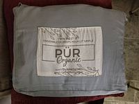 Front of fabric pouch showing PÜR Organic branding and material details