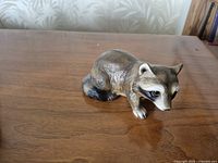 front angled view of raccoon figurine