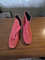 Top view of the pair of red suede ankle boots