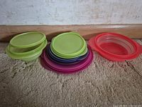 All bowls and lids displayed flat, showing colours and missing lid