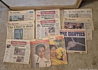 Group shot of all newspapers and magazine inserts spread on floor