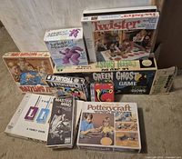 All nine boxed games and pottery kit stacked together