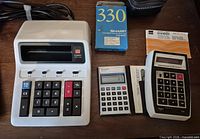 All three calculators with accessories laid out