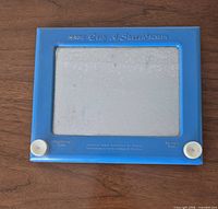 Front view showing blue frame, white knobs, text, and hazy screen