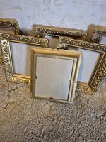 Back of one frame showing backing and hanging loops