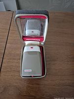 Shaver seated inside open zippered case