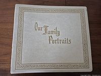 Front cover of ivory album with gold border and title