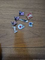 Group overview of all nine pins laid on wooden surface