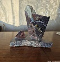 Front view of stone marble clock showing dial, hands, Roman numerals and base