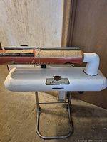 Front view of Thor Gladiron ironer on stand with AutoMagic tube on top